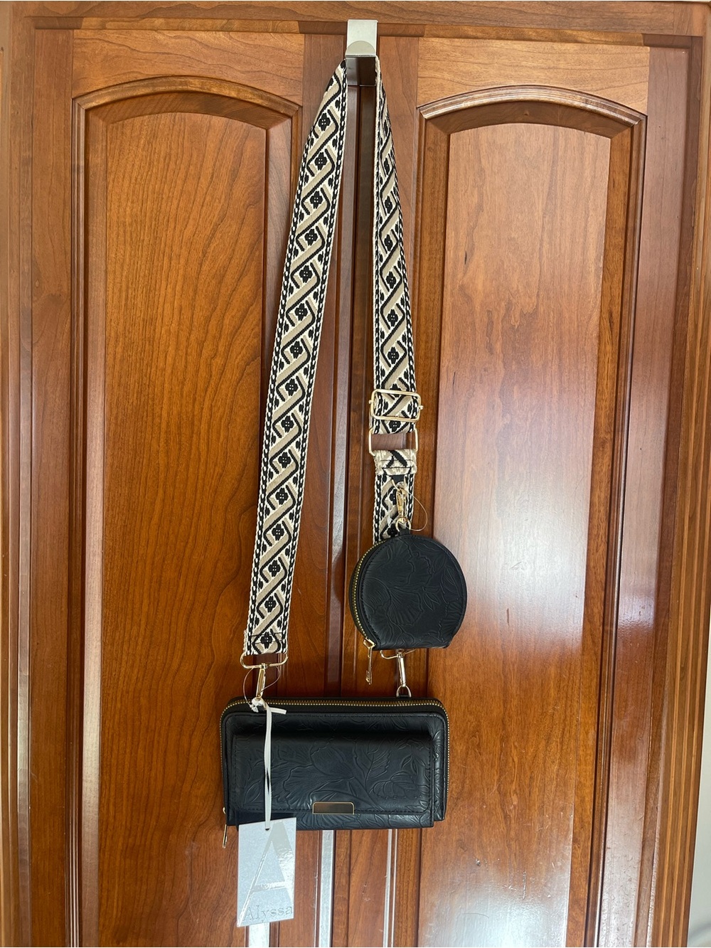 Black Embossed Crossbody Wallet with Patterned Strap and Coin Pouch